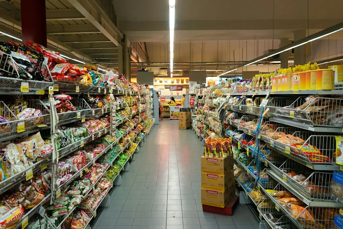Well-stocked retail store aisle with merchandise on shelves