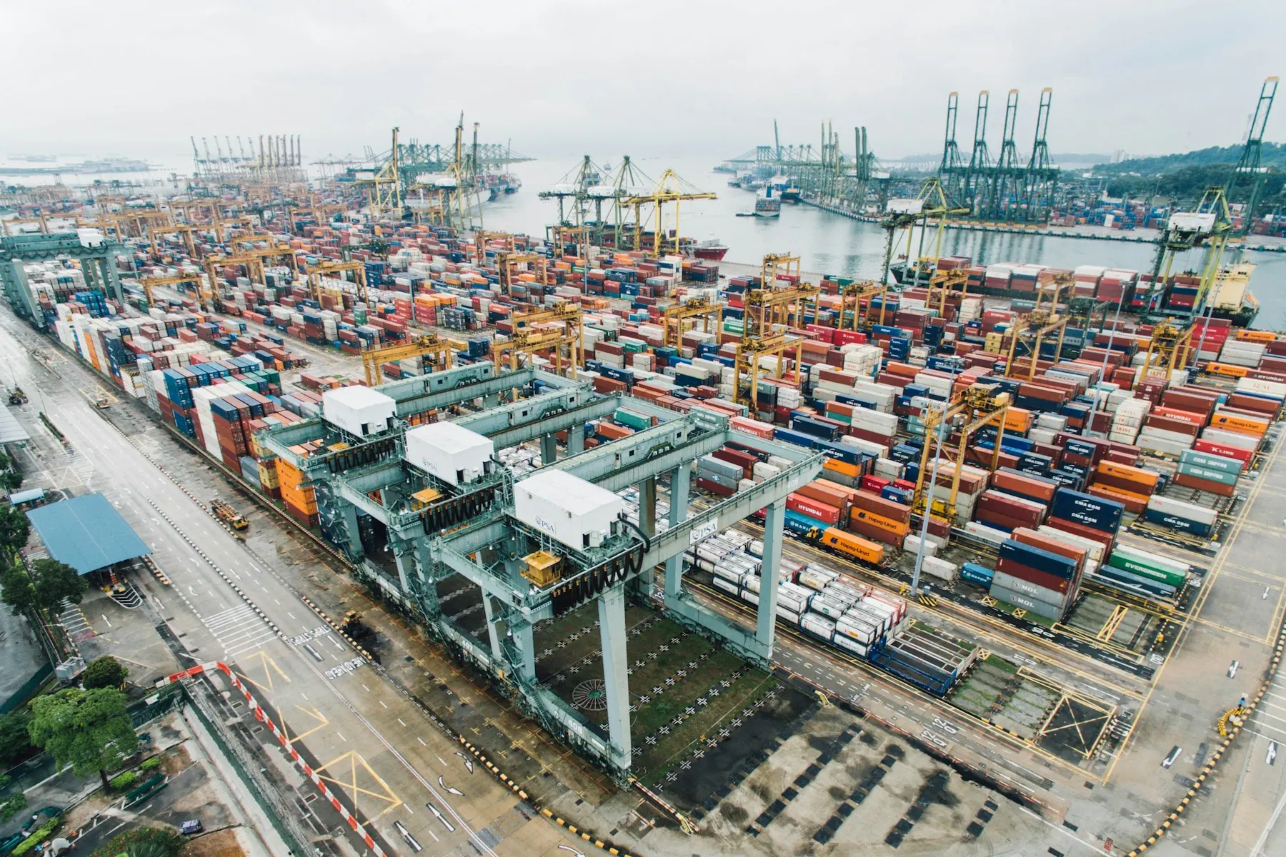 Aerial view of a container terminal with cranes, containers and vessels